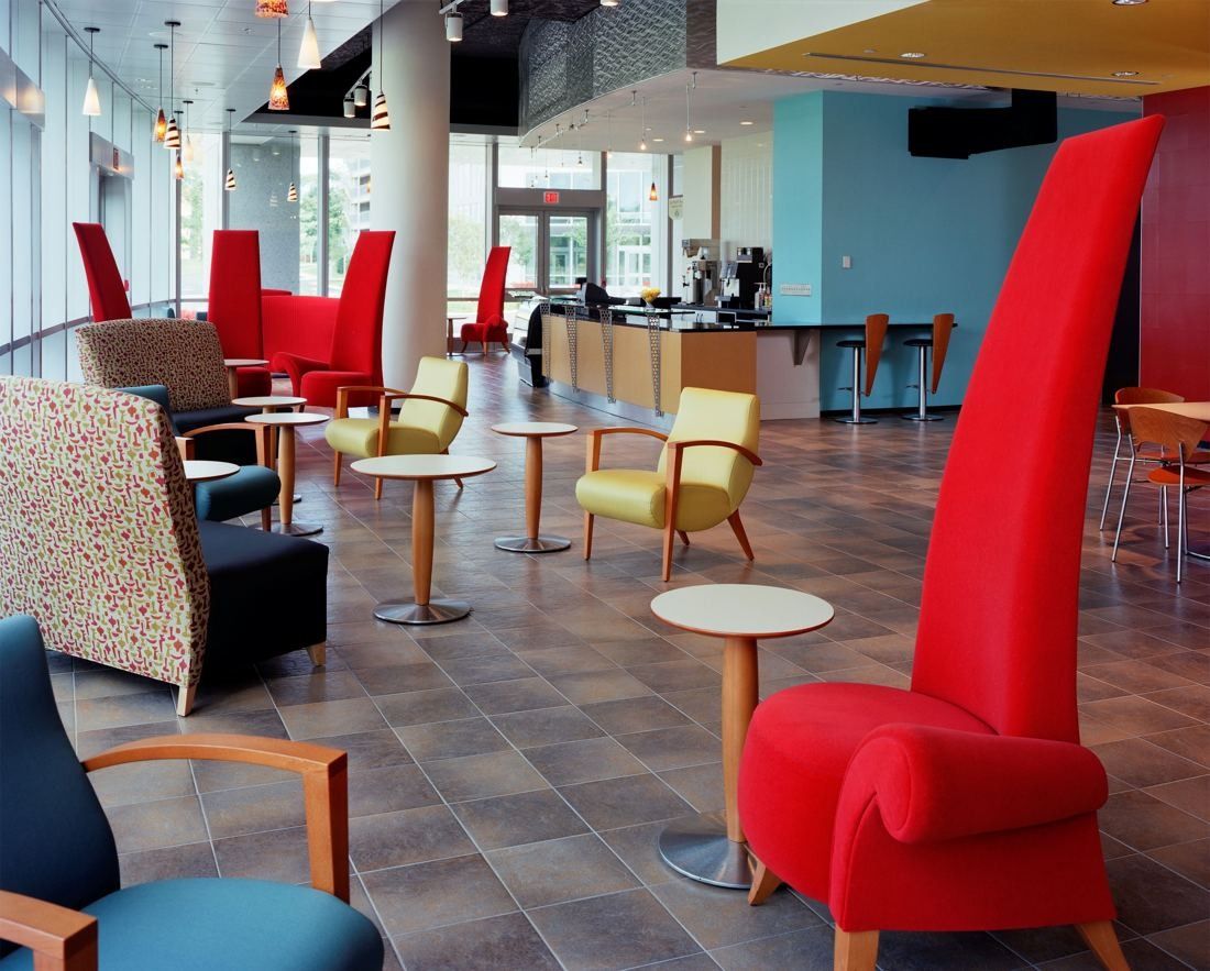 Capital One: Cafe with bright red high-back chairs and round tables