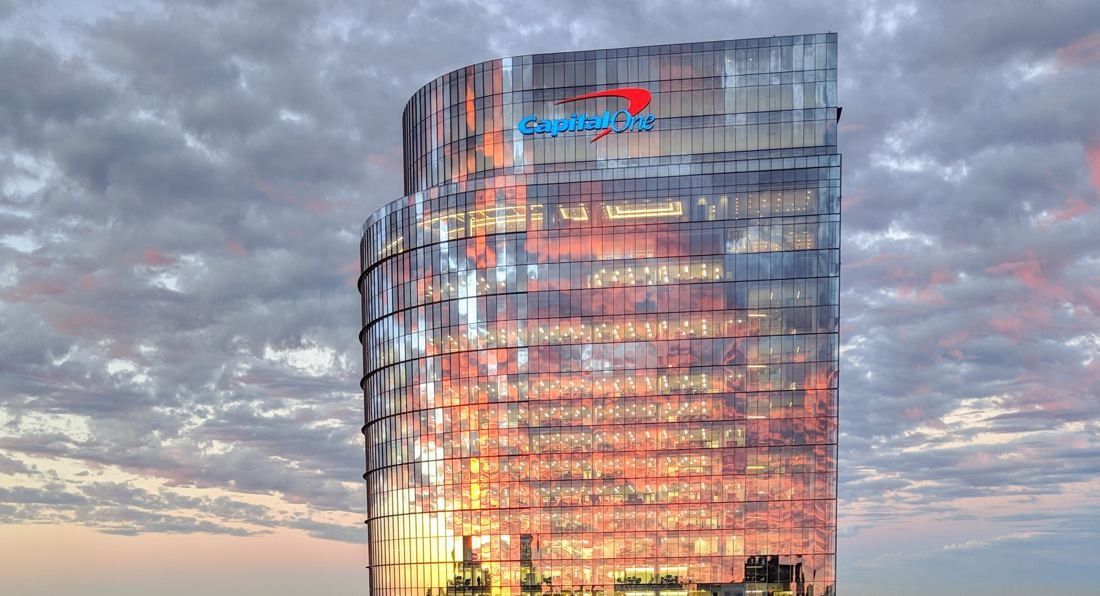 Capital One: Curved glass tower top reflecting a sunset sky