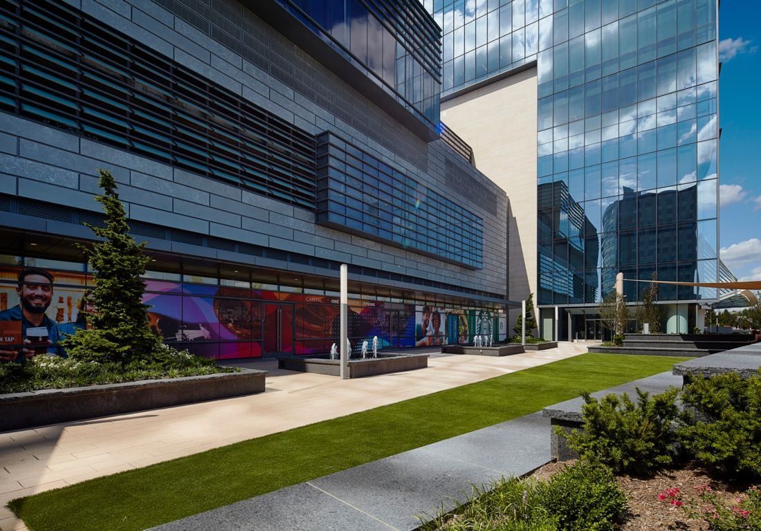 Capital One: Landscaped terrace with lawn and planting between glass facades