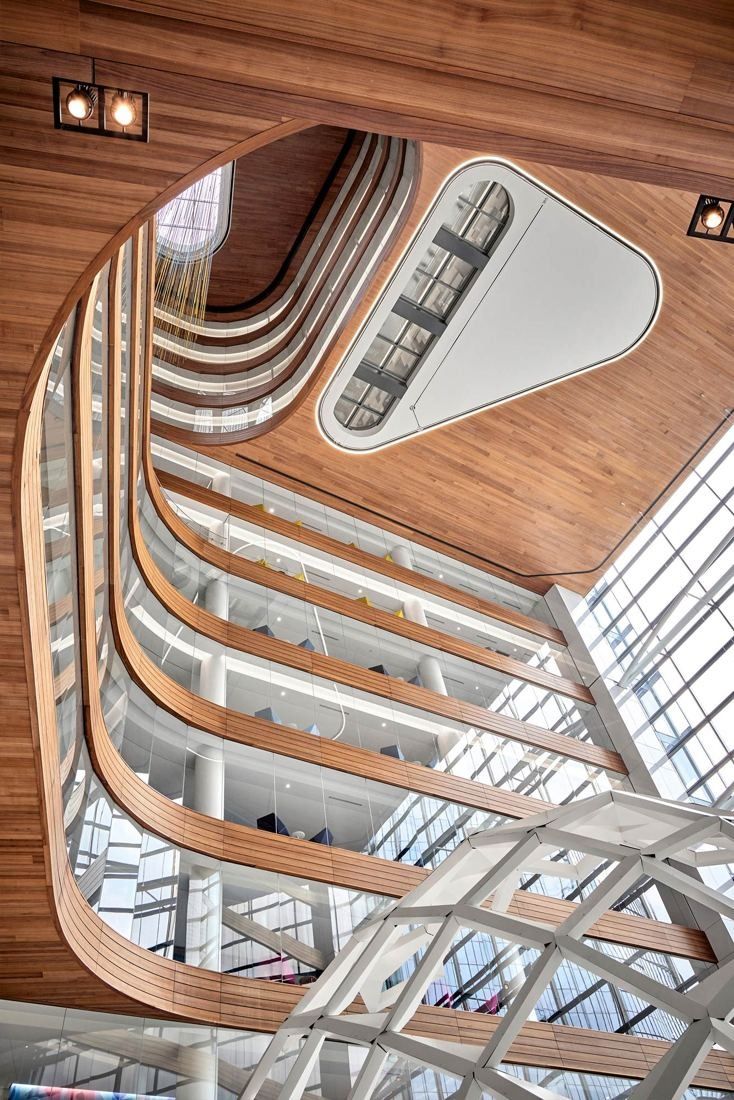 Capital One: Looking up through stacked curving wood-lined balconies to a skylight