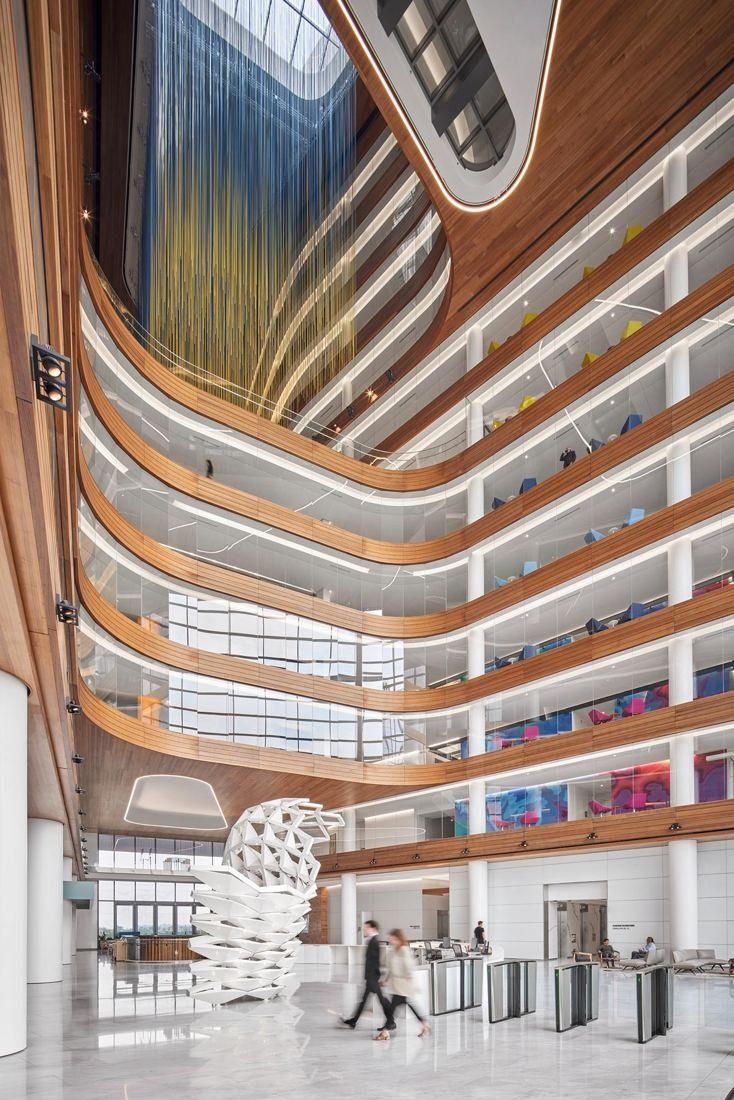 Capital One: Multi-story atrium with curving wood-clad balconies and a white lattice sculpture
