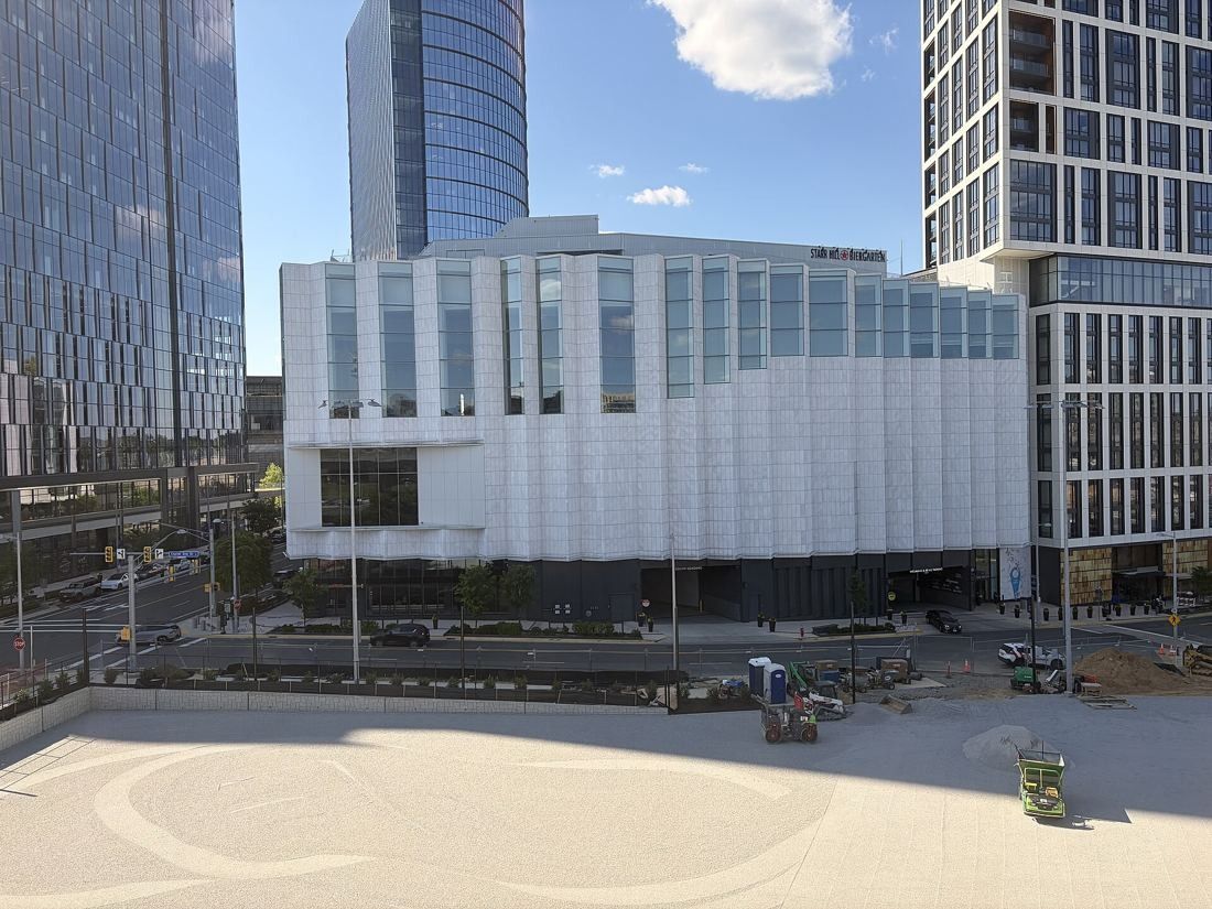 Capital One: White hall building with tall windows facing an open plaza