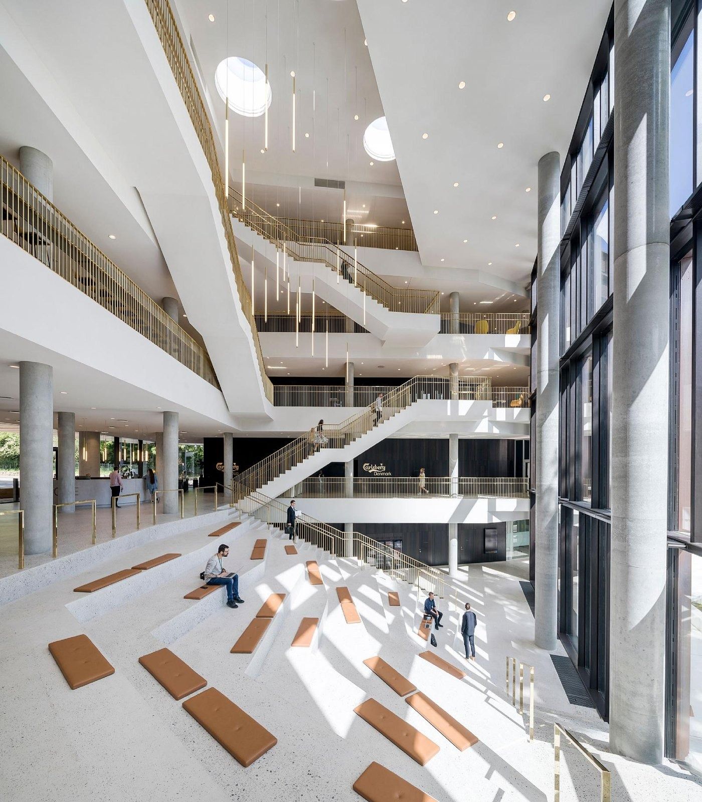 Carlsberg: Atrium with stepped seating and balconies of several floors under round skylights