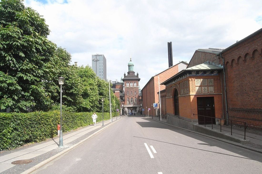 Ny Carlsberg Vej with brick brewery buildings and the gate tower