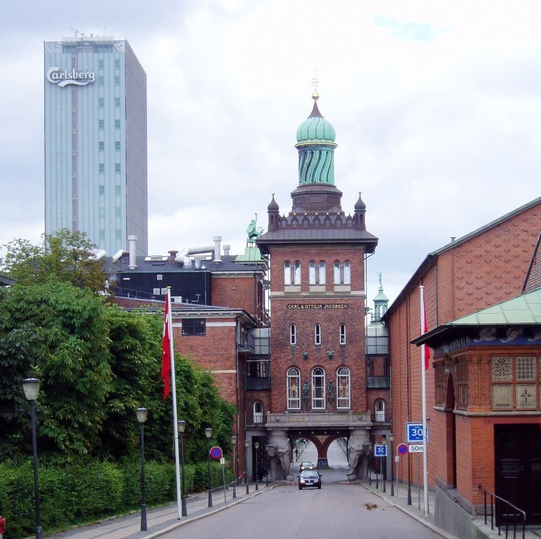 Red brick brewery gate tower with a green copper dome
