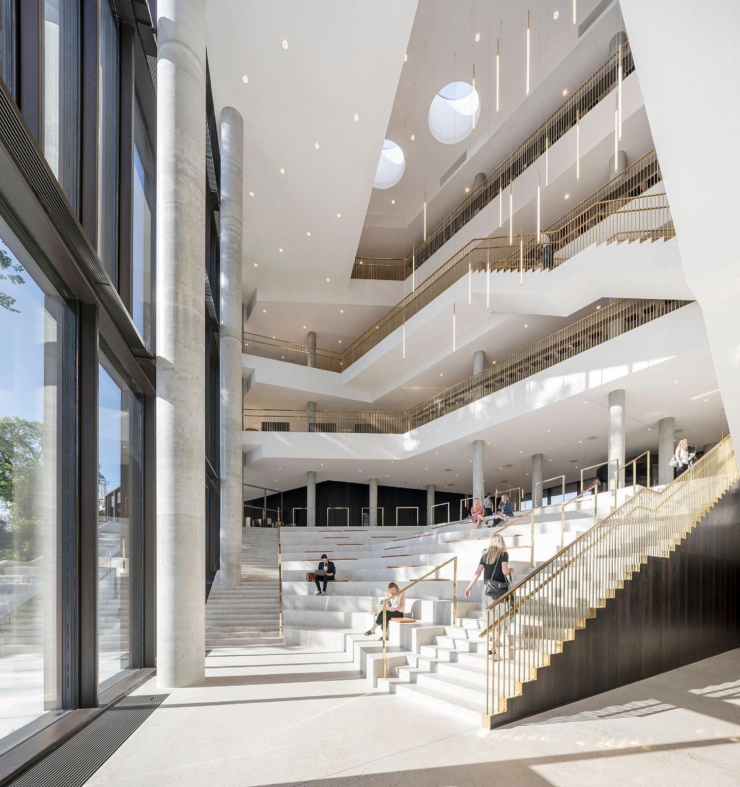 Carlsberg: Tall atrium with a white staircase, glass wall and open balconies above