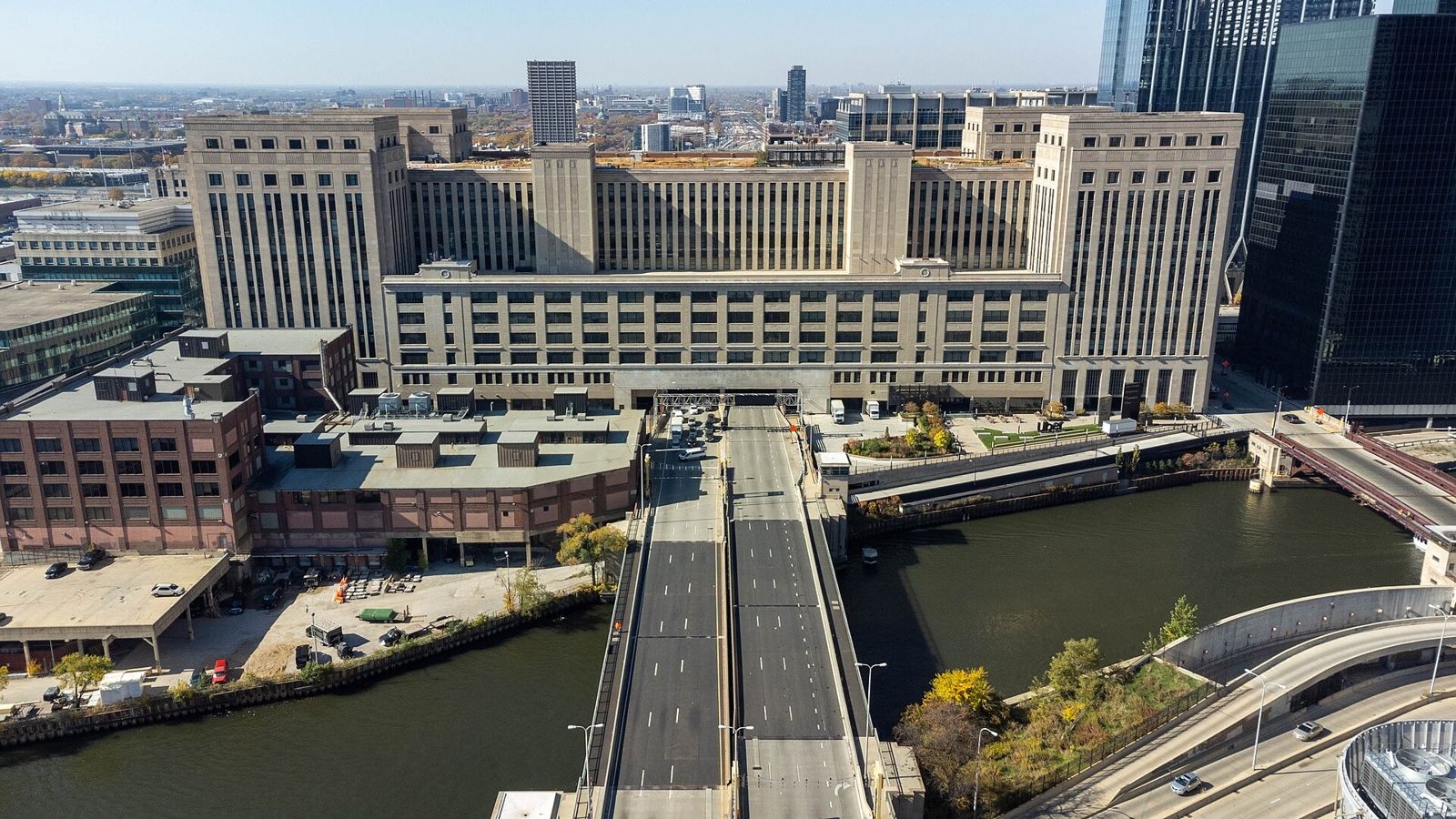 Cboe Global Markets: A huge limestone post office building straddling a highway beside the river