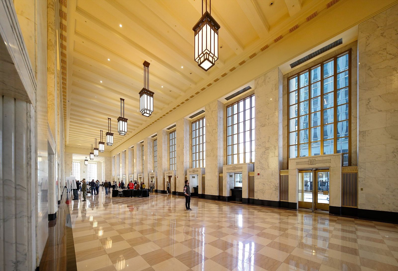 Cboe Global Markets: A long marble lobby with tall windows and hanging lanterns