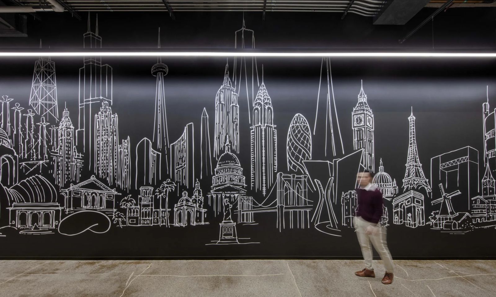 Cboe Global Markets: A man by a black wall drawn with landmarks from cities around the world