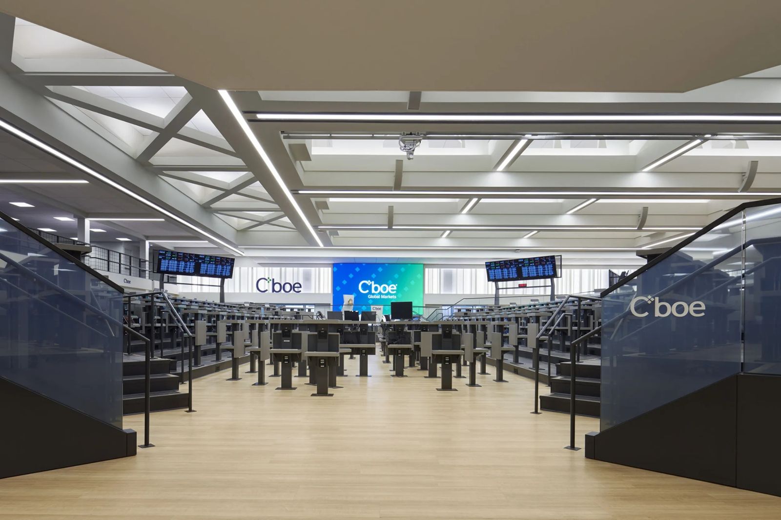 Cboe Global Markets: A trading floor with rows of standing desks and Cboe screens under a skylit ceiling