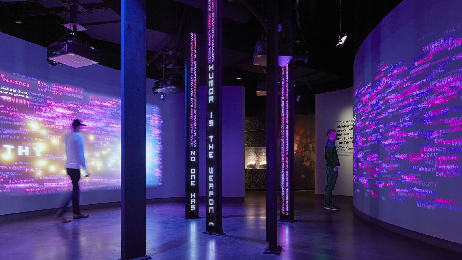 Cboe Global Markets: People walking past glowing purple digital walls in a dark room