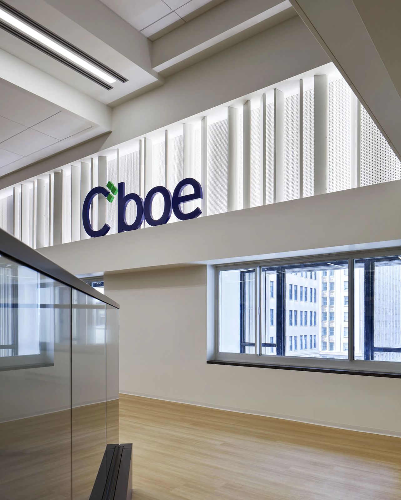 Cboe Global Markets: The Cboe name on a white wall beside a glass railing and windows