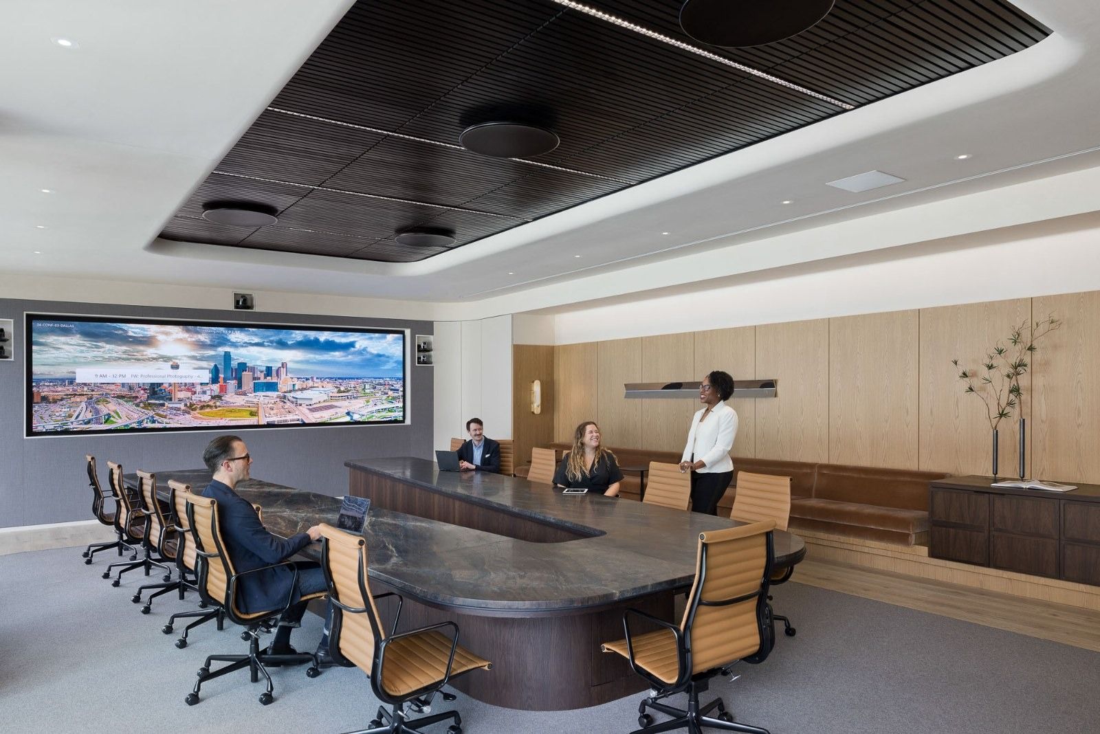 CBRE: A boardroom with a long dark table and a wide video screen