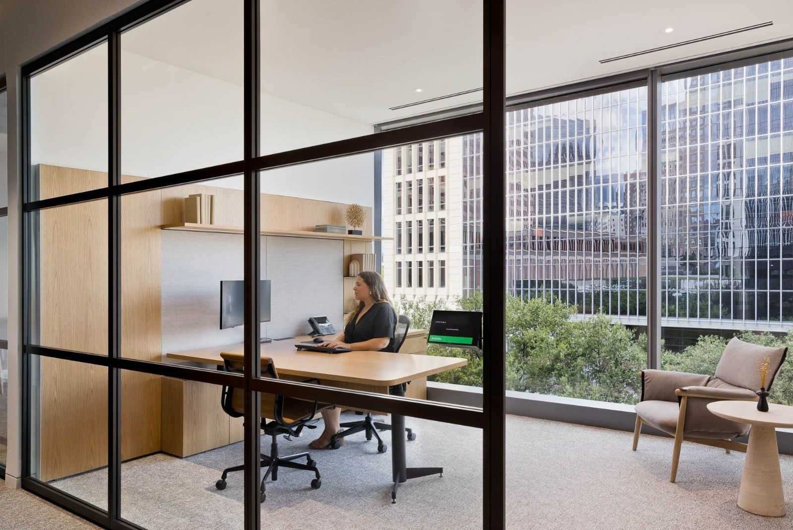 CBRE: A glass-fronted focus room with a desk and city view