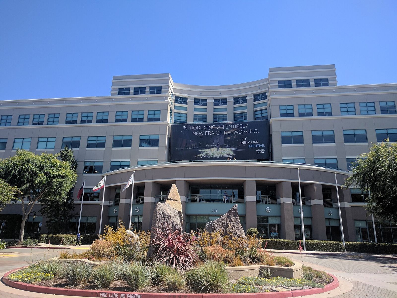 Cisco: A Cisco building entrance with a garden