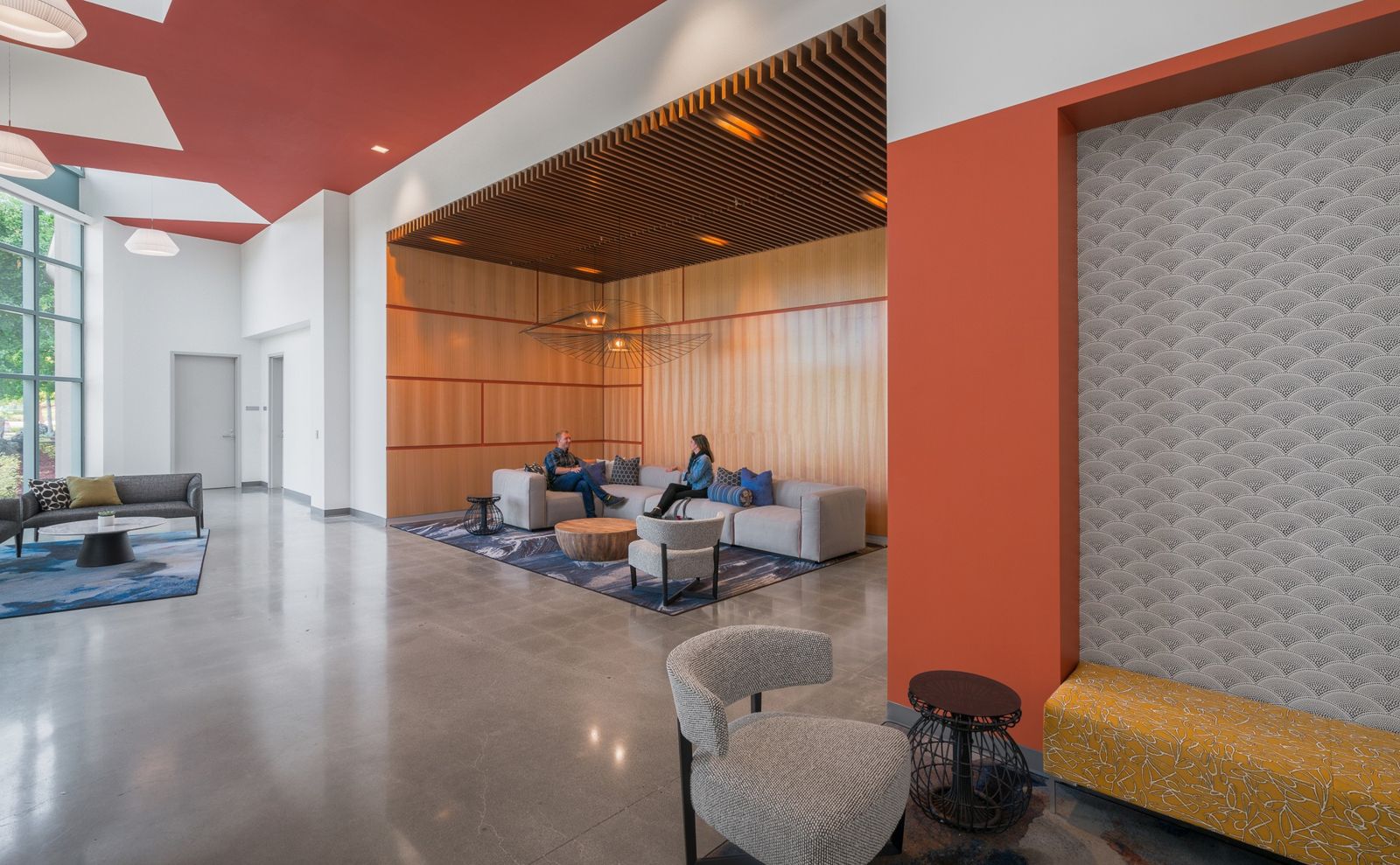 Cisco: A lounge with an orange wall and wood panels