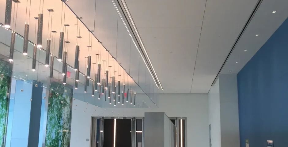 Citigroup: Hall with rows of pendant lights and a blue wall