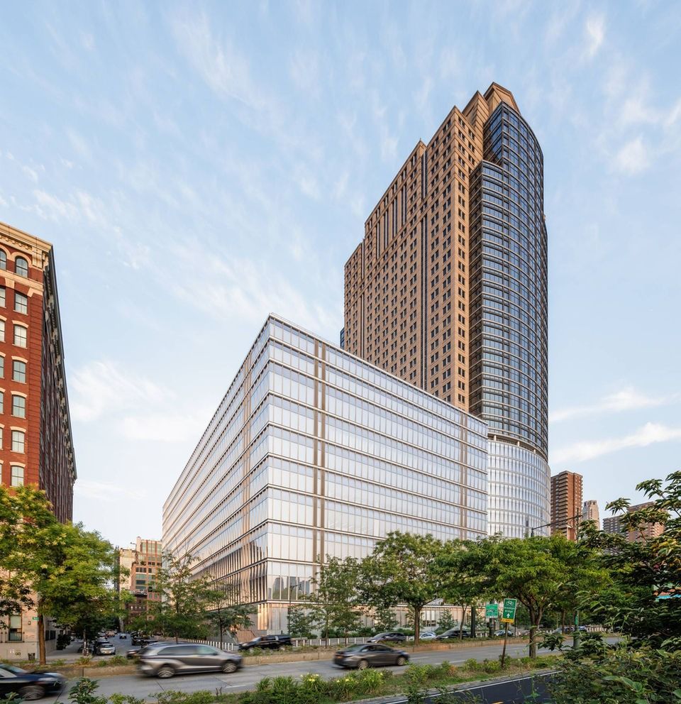 Citigroup: Low glass building in front of a tall stone-and-glass tower
