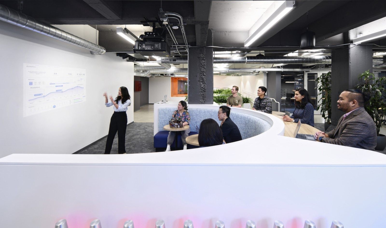 Cloudflare: A white curved bench in a meeting area