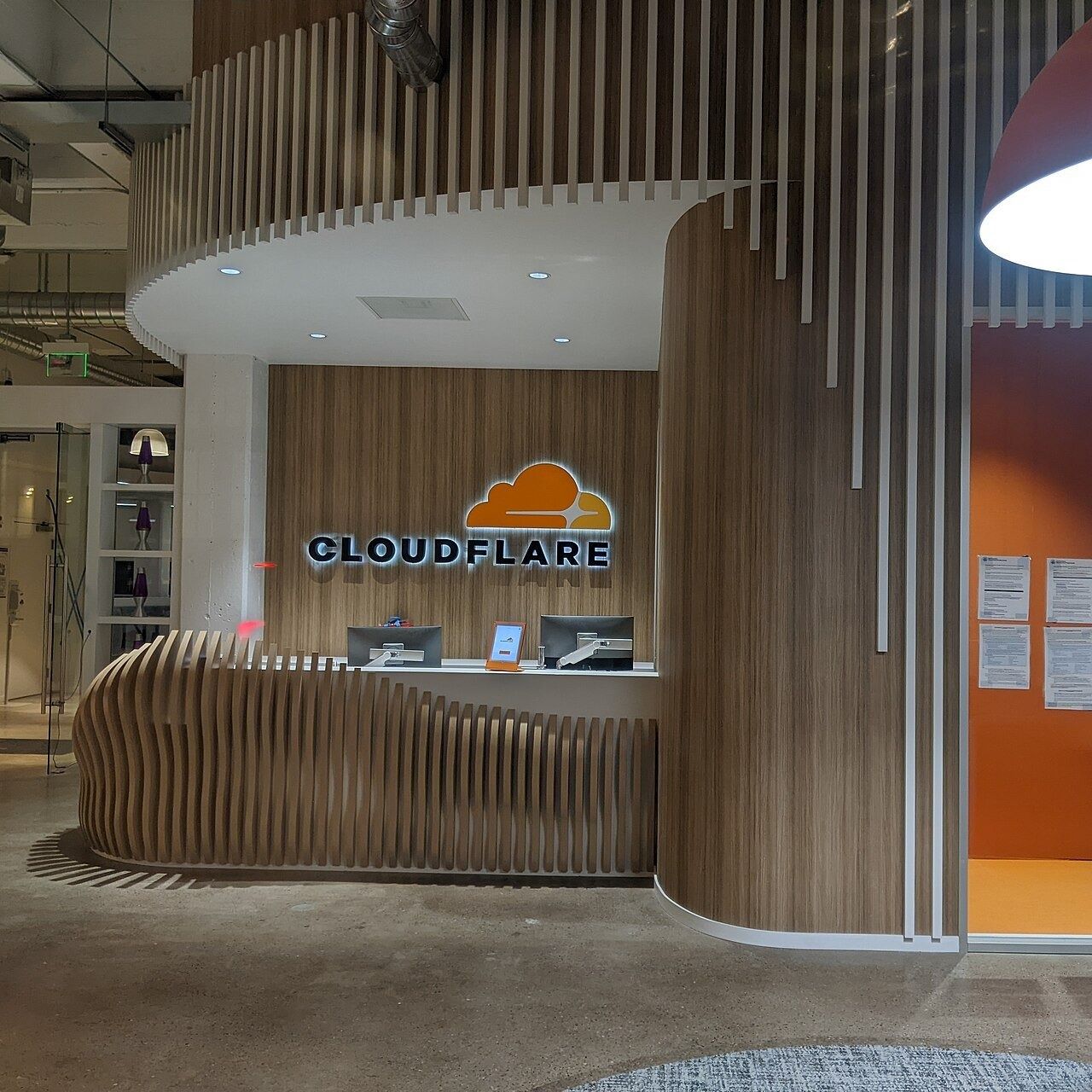 Curved wooden reception desk at Cloudflare's office