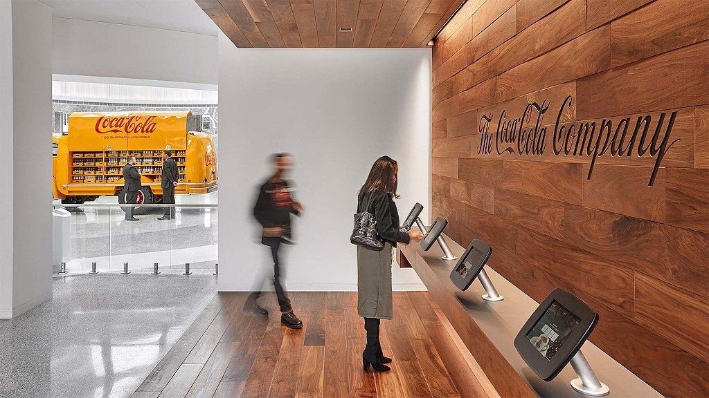 The Coca-Cola Company: Reception with a wood wall and the company script