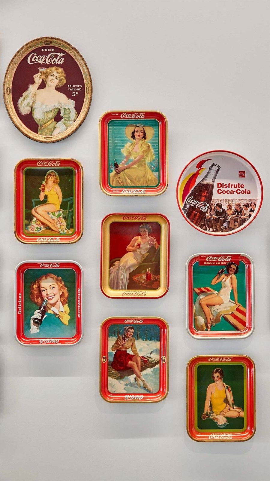 The Coca-Cola Company: Vintage serving trays on a wall