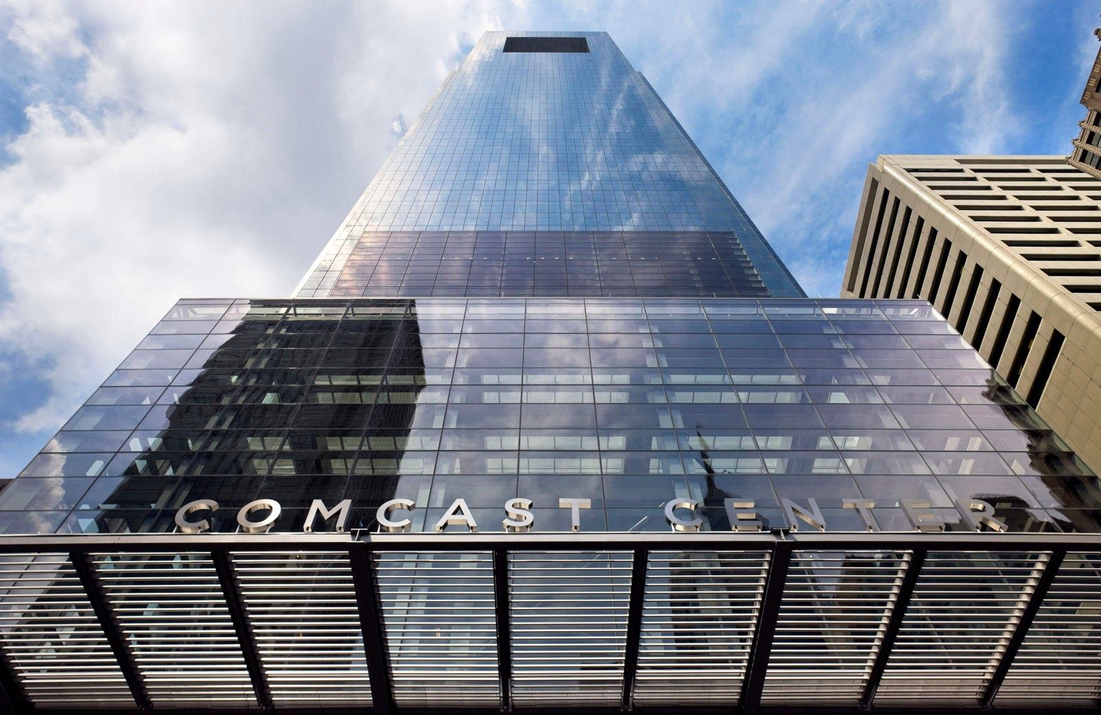 Comcast: Glass tower rising above the entrance canopy