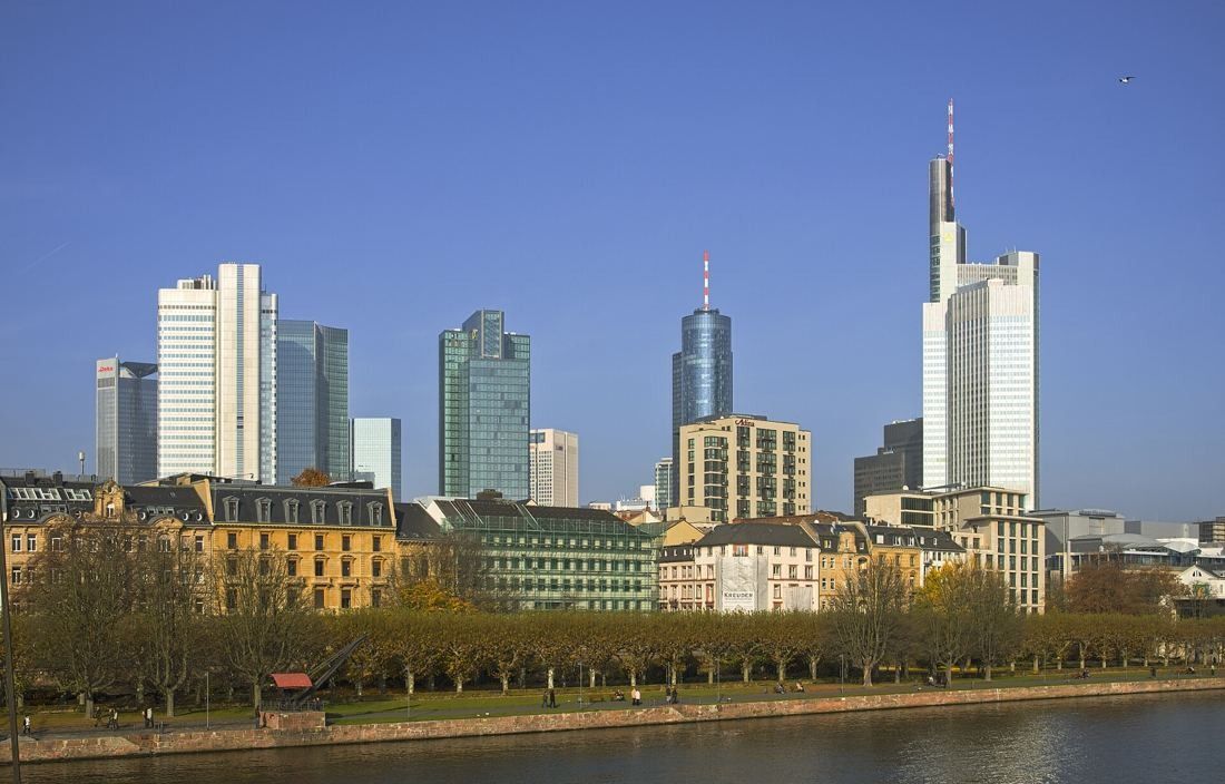 Commerzbank: Skyline across the river with older buildings along the bank and the tallest tower on the right