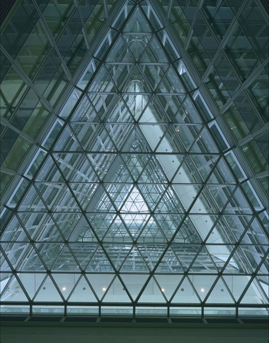 Commerzbank: Triangular glass atrium seen from below, with a lattice of steel and glass rising many storeys