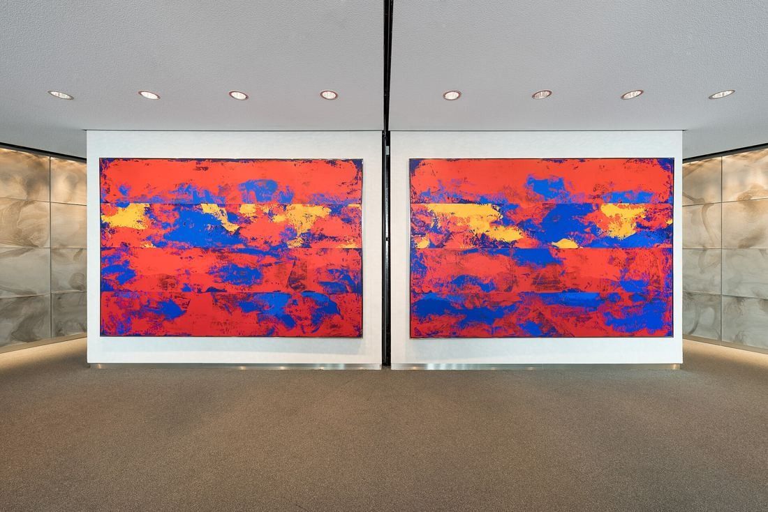 Commerzbank: Two large red and blue abstract paintings on a pale wall in a carpeted room
