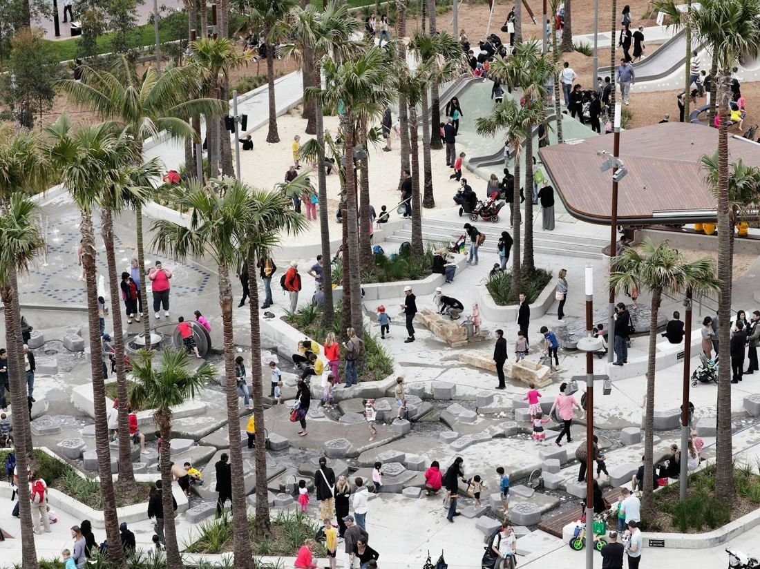 Commonwealth Bank of Australia: Aerial view of a busy public square with palms and play areas beside the office buildings