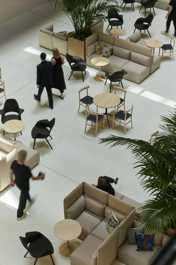 Commonwealth Bank of Australia: Looking down on a lounge with sofas, small round tables and potted palms