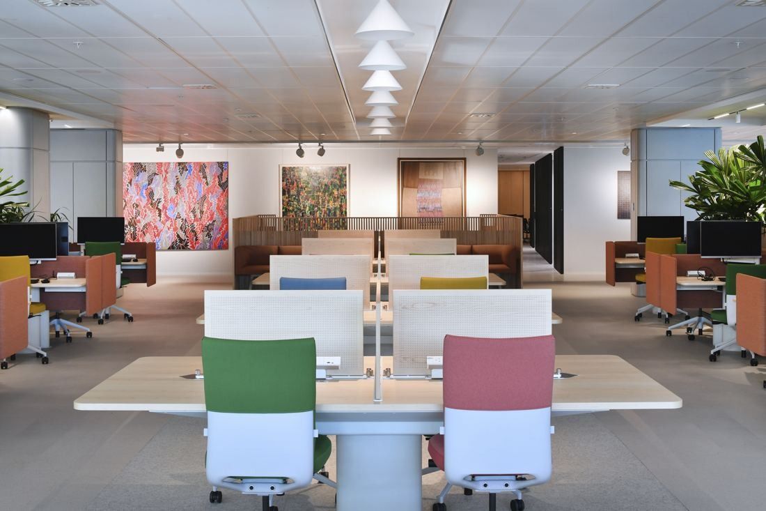 Commonwealth Bank of Australia: Open office with white desks, colourful chairs and artworks on the walls