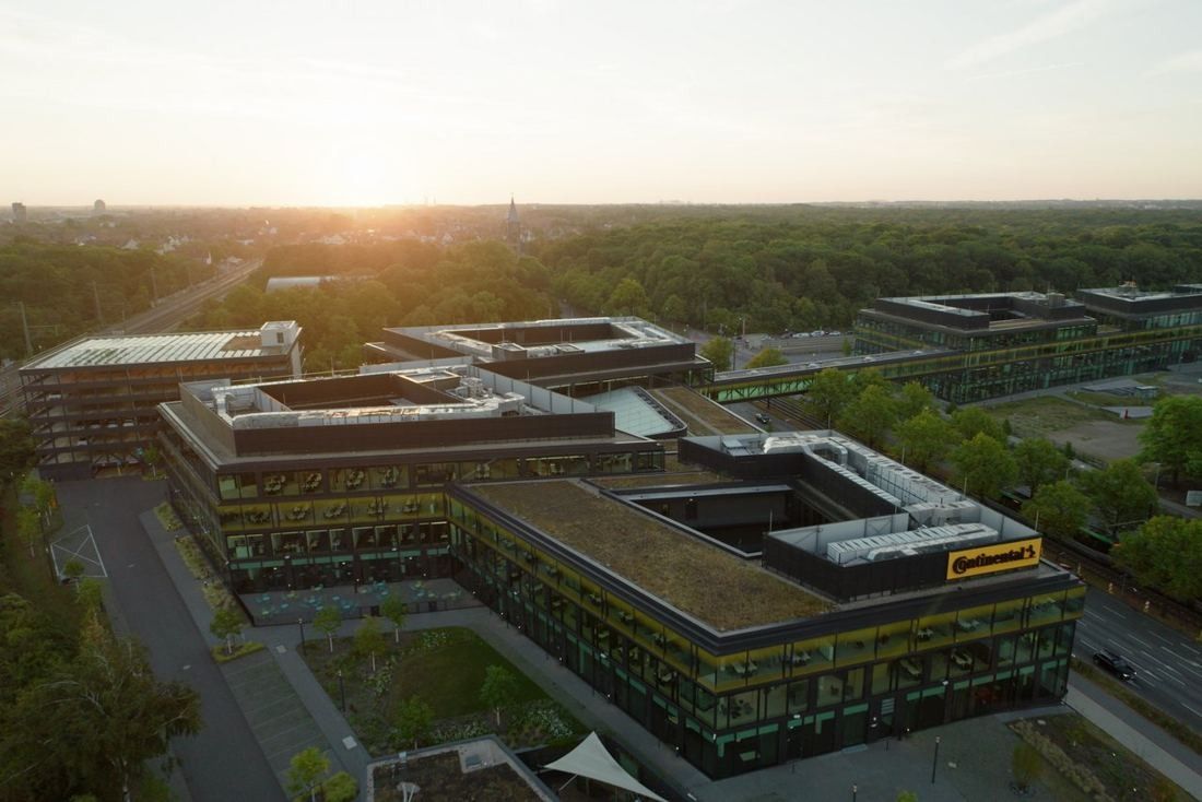 Continental: Aerial view at sunset of courtyard office buildings with green roofs and a yellow sign