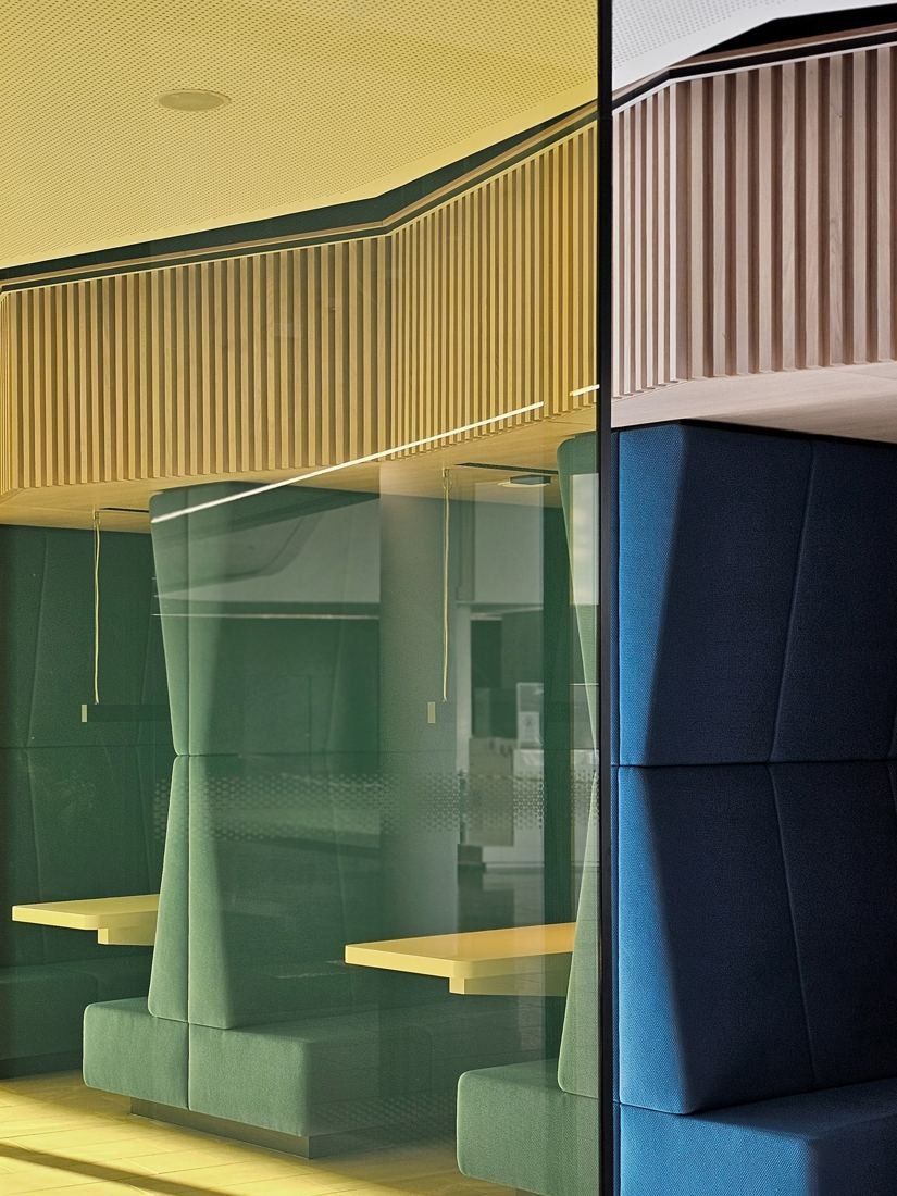 Continental: Green and blue upholstered booth seating with yellow and wooden slatted panels