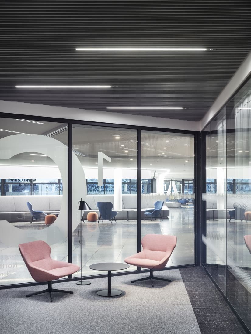 Continental: Pink lounge chairs by a glass wall, with an open area behind