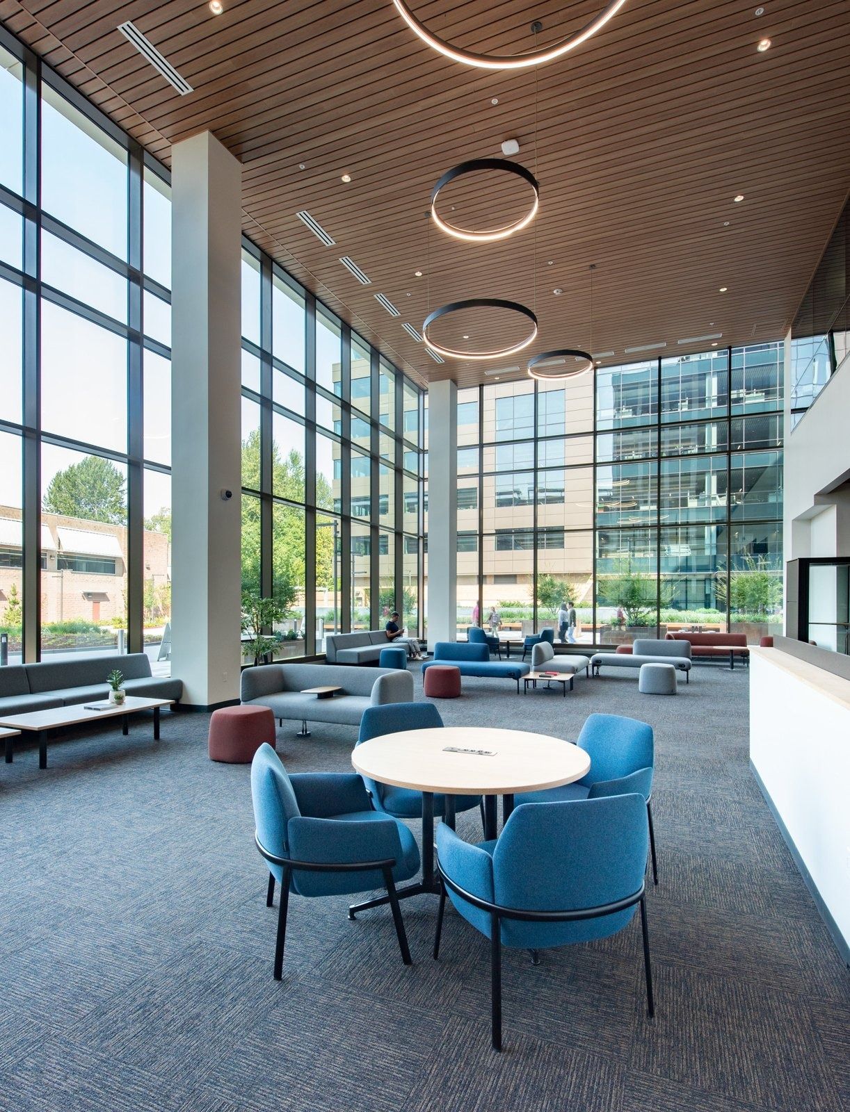 Costco Wholesale: A double-height lounge with blue chairs and ring lights