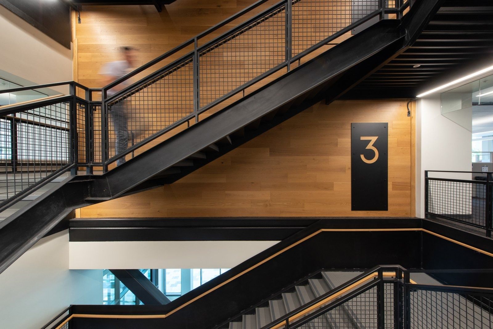 Costco Wholesale: A wood-clad stair with black steel railings