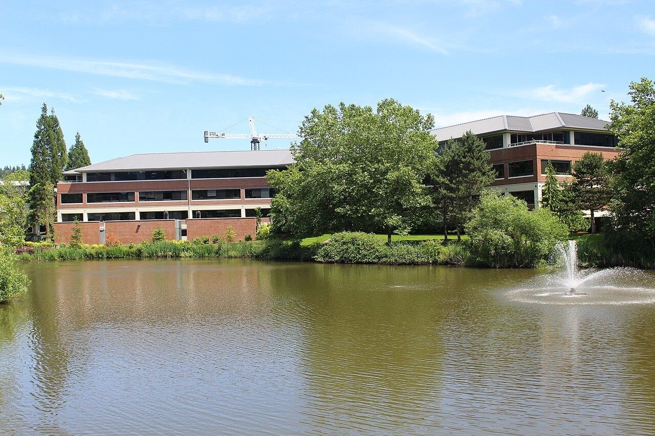 Brick office building beside a pond with a fountain