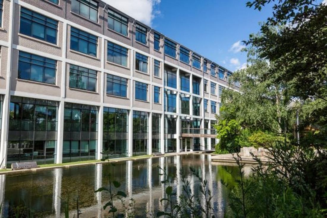 Crédit Agricole: An office building with tall windows reflected in a canal