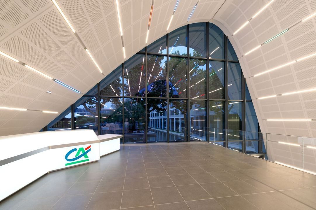 Crédit Agricole: Inside the pavilion: a curved white ceiling with light strips over a reception desk
