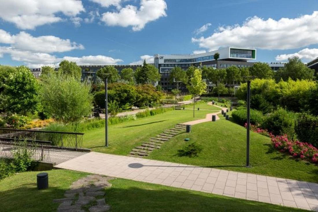 Crédit Agricole: Paths and lawns winding through a landscaped park between low office buildings