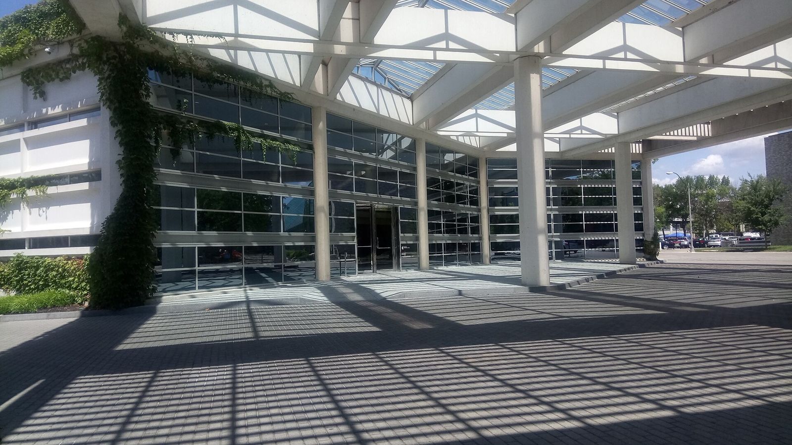 Cummins: Glass entrance under a white steel frame