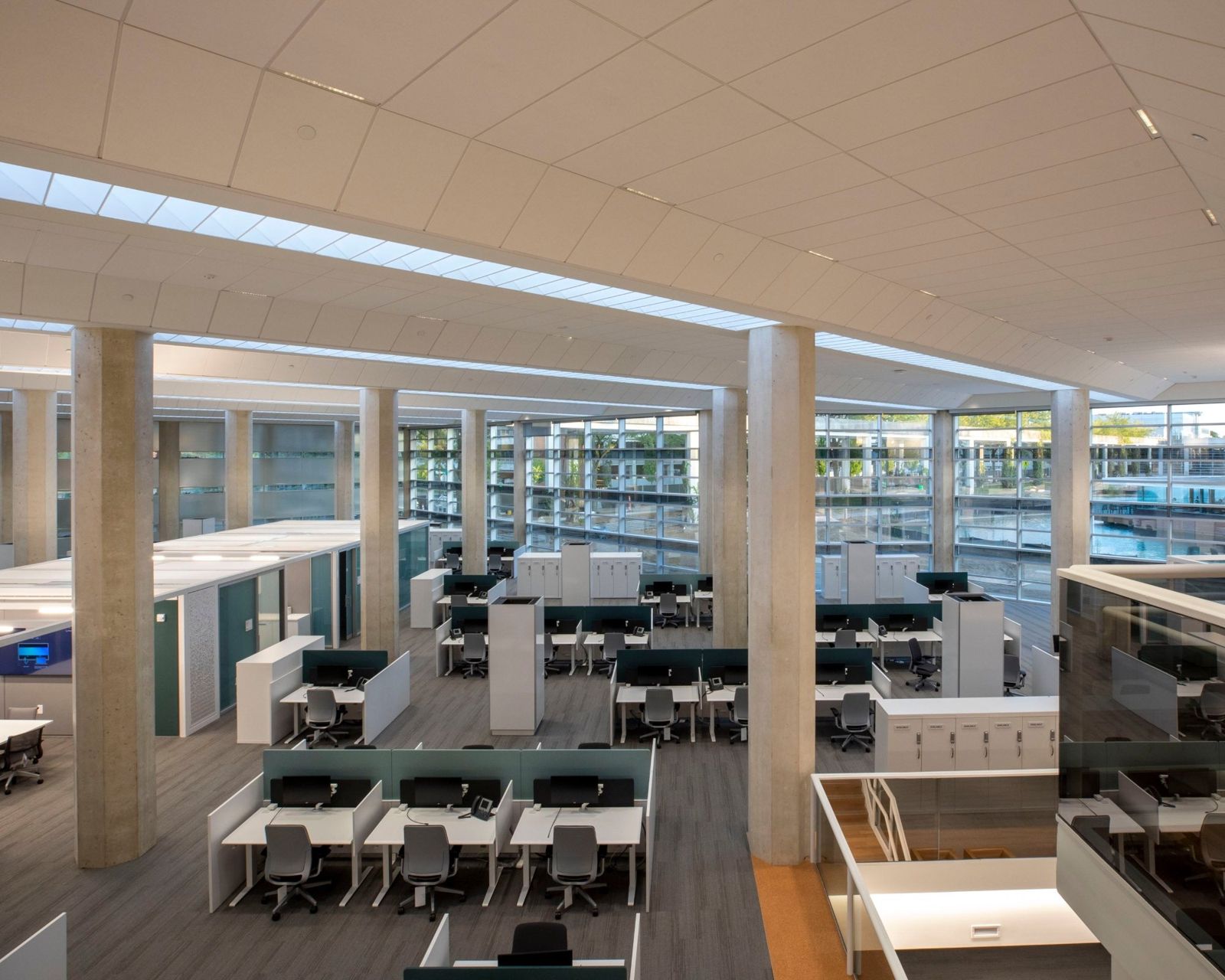 Cummins: Open office with desks along tall windows
