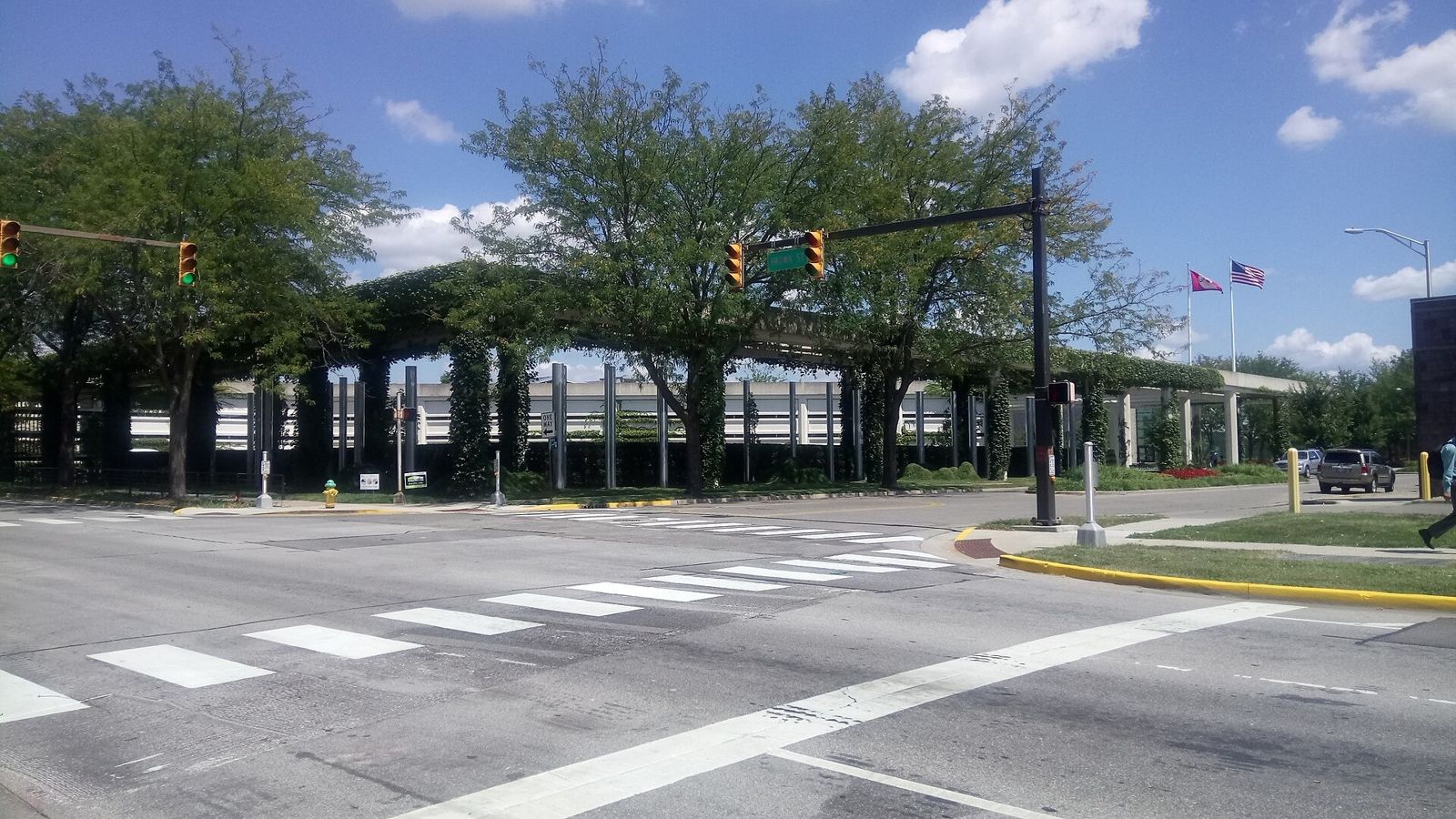 Street view of a long building under a trellis