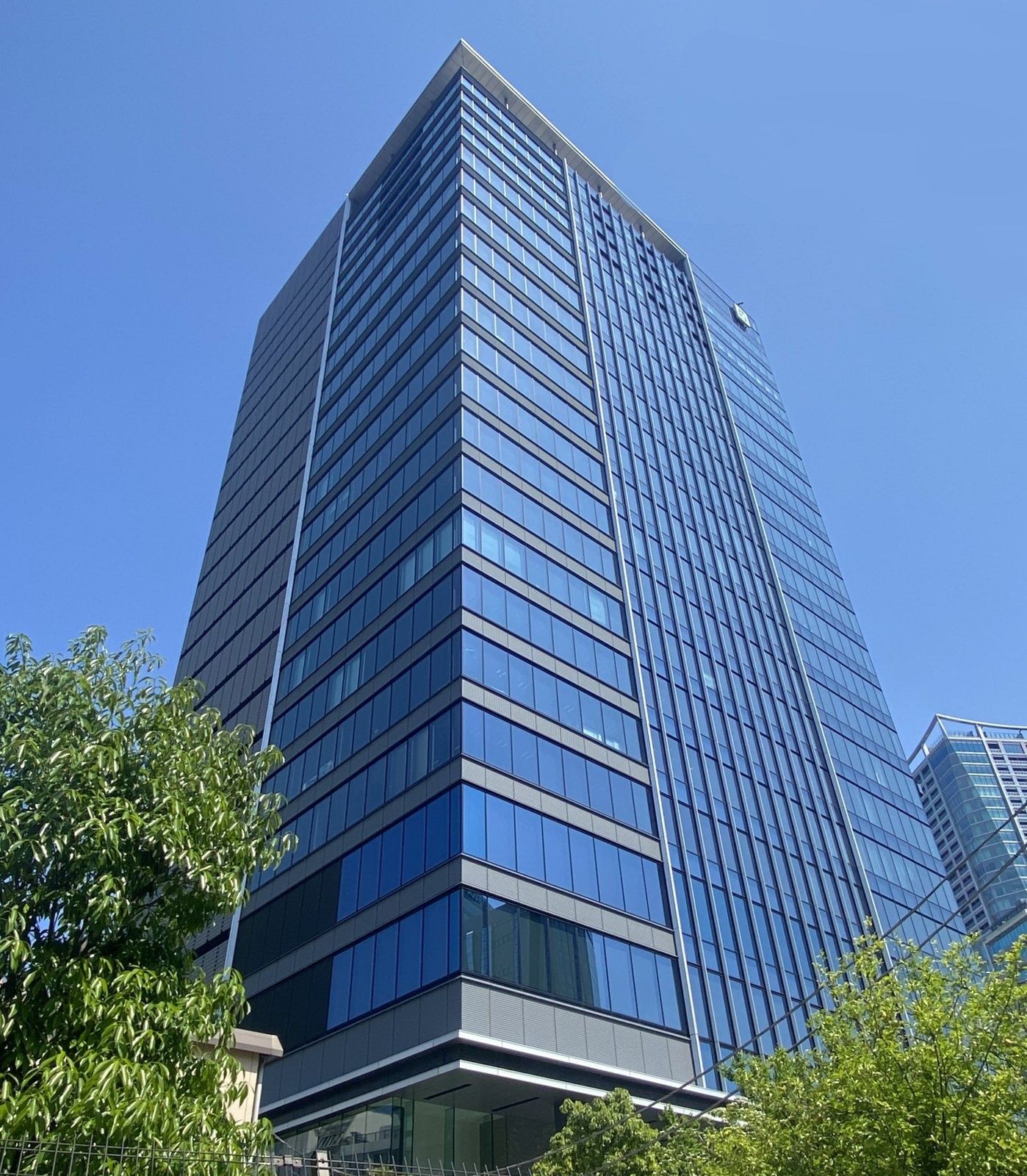 CyberAgent: Dark glass office tower above trees