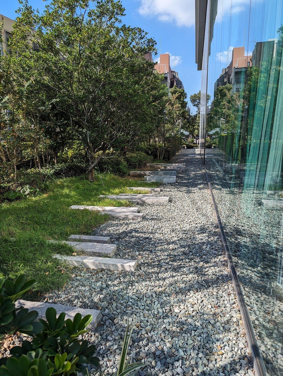 CyberAgent: Gravel garden path along a glass wall