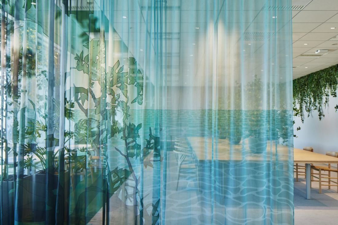 Cybozu: Sheer curtain printed with sea and plants dividing a meeting area