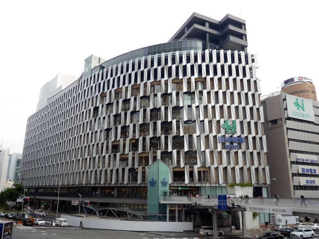 Daikin: The curved, patterned lower block with a shorter building section on top, seen from across the street