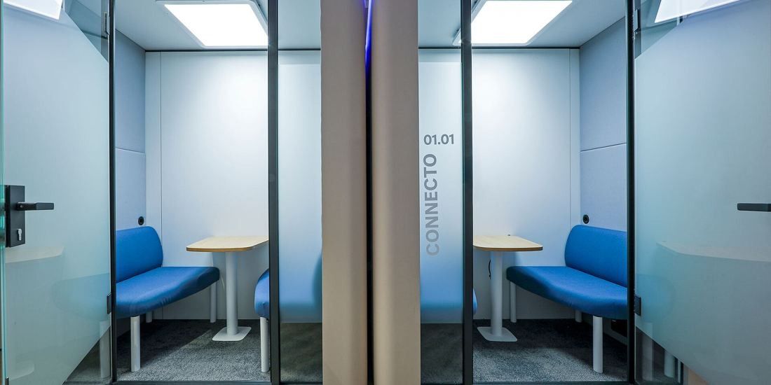Danone: Two glass booths with open doors, each with blue bench seats facing a small table
